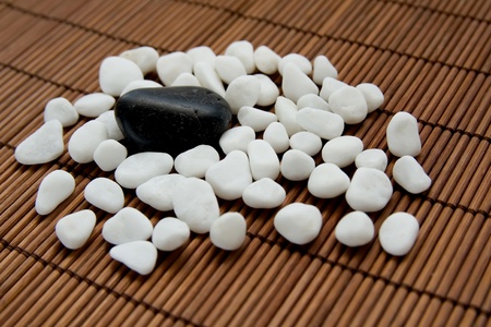 Composition with white and black stones, symbolizing harmony, calmness and relaxationの写真素材