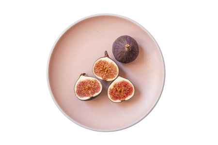 Fresh figs on plate isolated on white background. top view.