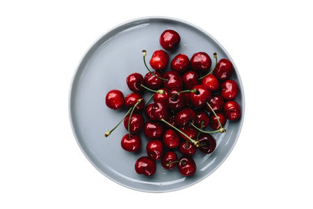 Cherries in a plate on a white background. Top view.