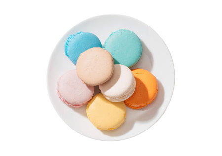 Colorful macaroons on white plate isolated on white background.の写真素材