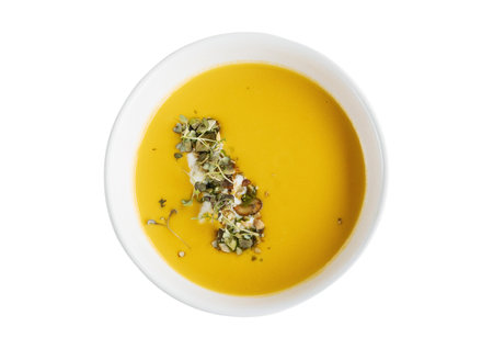 Pumpkin soup in a bowl isolated on a white background.の写真素材
