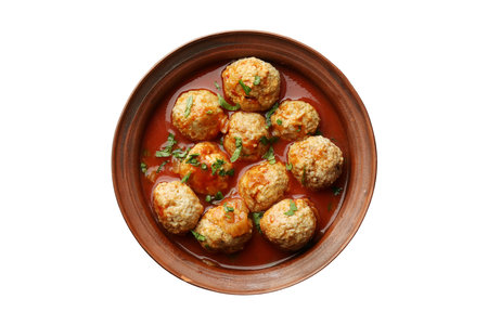 Meatballs in tomato sauce in bowl on white background, top viewの写真素材