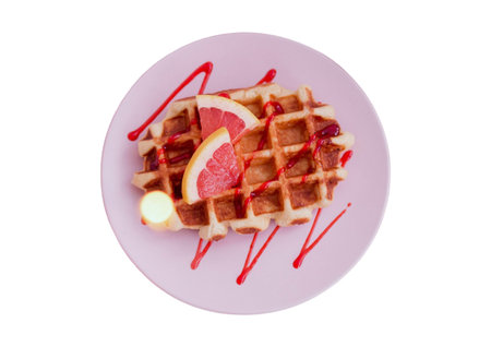 Belgian waffles with grapefruit and strawberry sauce isolated on white backgroundの写真素材