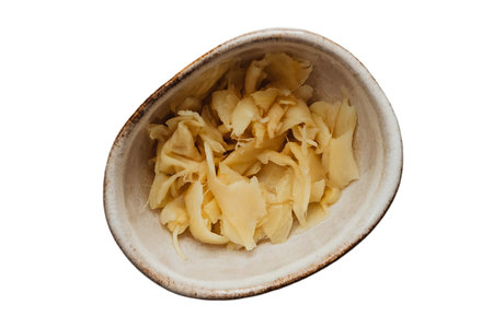 Close up of a bowl of pickled ginger isolated on white backgroundの写真素材