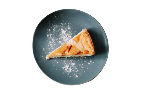 Slice of apple pie on a blue plate isolated on white backgroundの写真素材