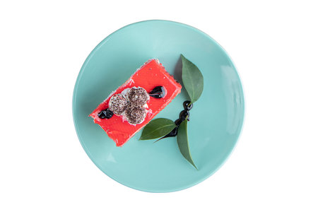 red velvet cake with blackberries on blue plate isolated on white backgroundの写真素材