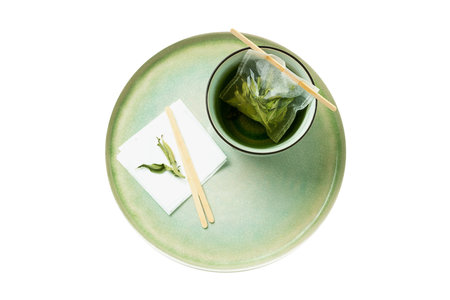 Green tea in a cup with chopsticks isolated on white background.の写真素材