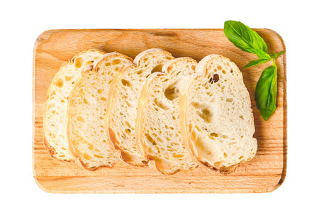 Slices of bread on a cutting board isolated on white background