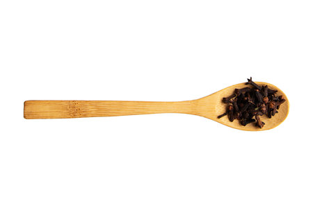 Cloves in wooden spoon isolated on white background. Cloves in wooden spoonの写真素材