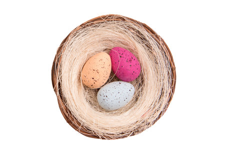 Colorful easter eggs in a basket isolated on white background.