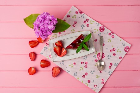 Piece of chocolate cake with strawberries on the tableの写真素材