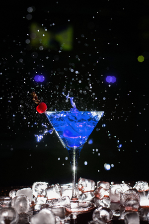 Splash in glass of a pink alcoholic cocktail drink isolated on white backgroundの写真素材