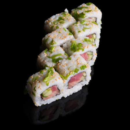 Sushi rolls with salmon, tuna, cucumber and green onions on black backgroundの写真素材