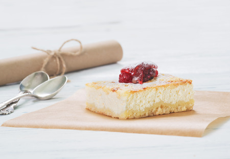 Cheesecake on baking paper on light backgroundの写真素材