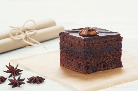 Chocolate cake on baking paper on the light backgroundの写真素材