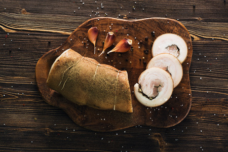 Lard roll with salt and garlic, wooden backgroundの写真素材