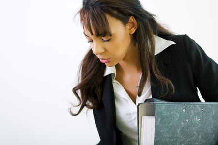A young female office worker carrying filesの写真素材