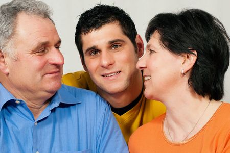 Family - mother, father, and adult son looking at each otherの写真素材