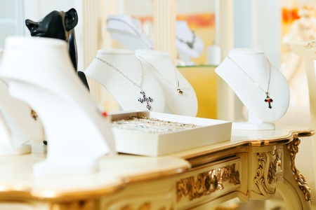 Display at a jeweller with necklace and ringsの写真素材