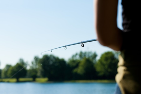 Fishing at the lake at a beautiful summer dayの写真素材