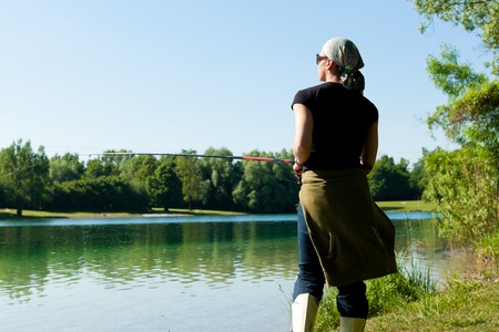 Fishing at the lake at a beautiful summer dayの写真素材