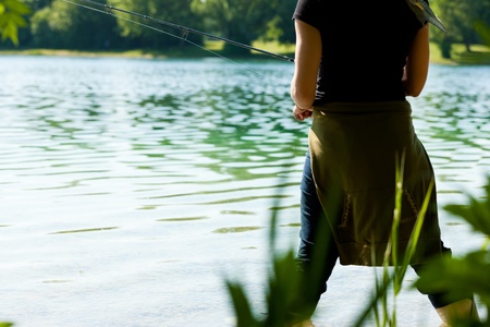 Fishing at the lake at a beautiful summer dayの写真素材