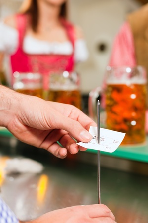 Waiter â only hands to be seen - in a Bavarian pub taking orders の写真素材