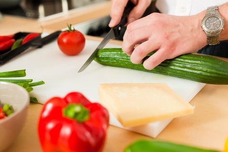 Man in the kitchen â only hands to be seen â is preparing the vegetables for dinner or lunchの写真素材