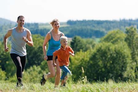 Active Family jogging outdoors in beautiful summer landscape  の写真素材