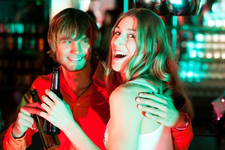 Couple having drinks in a bar or nightclub  の写真素材