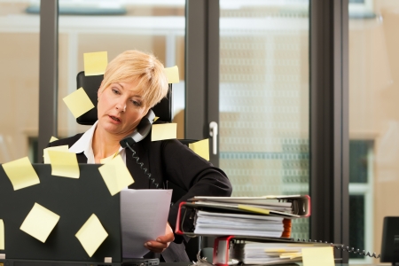 A woman has stress in the office - multitasking and time management A woman has stress in the office - multitasking and time management