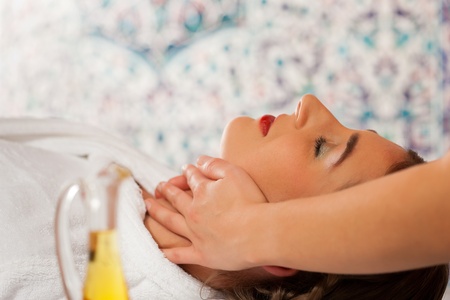 Wellness - woman getting massage or facial in Spa; it is a massage for the headの写真素材