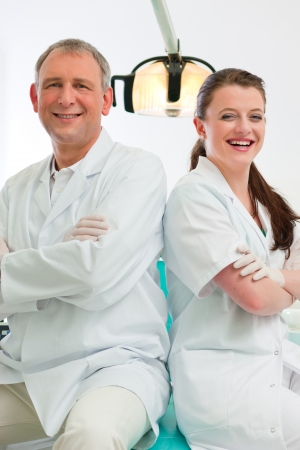 Dentists in their surgery looking at the viewer standing side by sideの写真素材