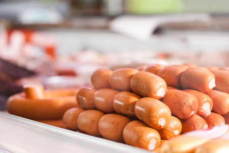 Varieties of fresh sausages for sale in a butcher shopの写真素材