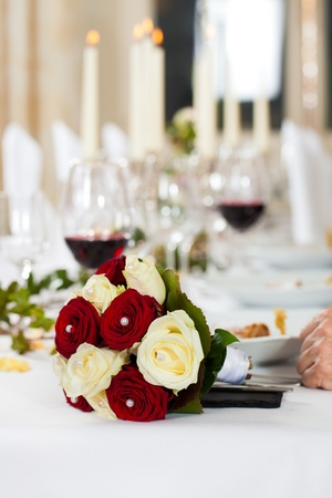 Bouquet at a wedding table; the wedding party is ongoingの写真素材