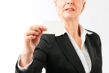 Mature woman showing her business card, closed-upの写真素材
