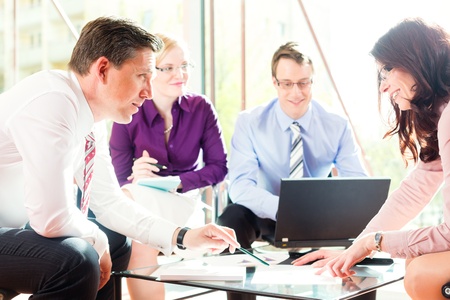 Business people having meeting or workshop in office profit growth graph and documents Business people having meeting or workshop in office profit growth graph and documents