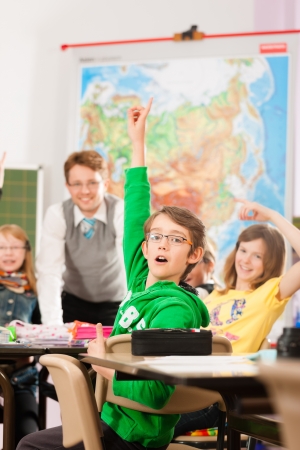 Education - Pupils and teacher learning at elementary or primary school in the classroomの写真素材