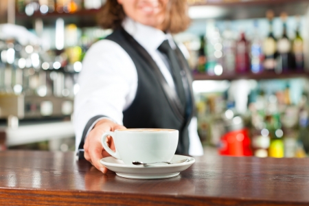 Barista making cappuccino in his coffeeshop or cafeの写真素材