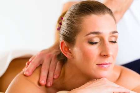 Woman enjoying a wellness back massage in a spa, she is very relaxed の写真素材