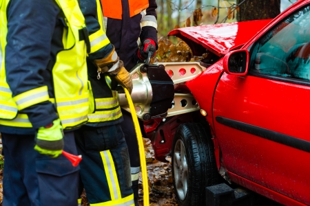 Accident - Fire brigade rescues accident Victim of a car using a hydraulic rescue tool