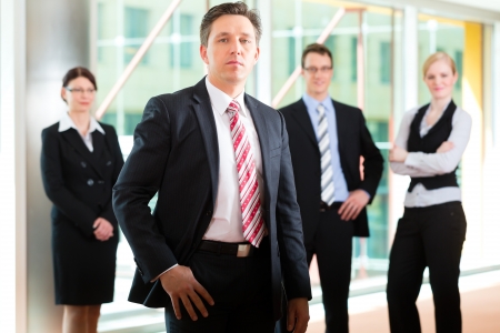 Business - group of businesspeople posing for group photo in officeの写真素材