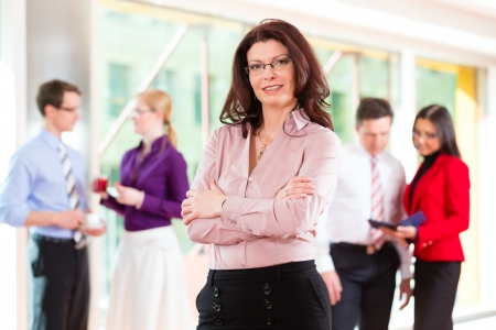 Business people or team in office, a woman is looking to the viewer の写真素材