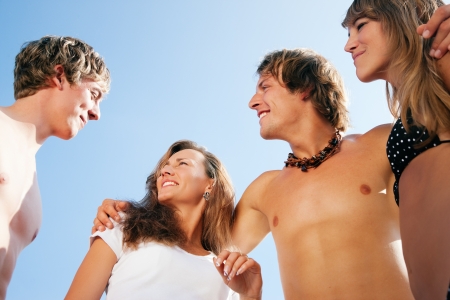 Group of four very beautiful people - men and women - on the beach の写真素材