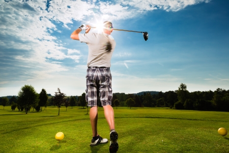 Young golf player on course doing golf swing, he presumably does exerciseの写真素材