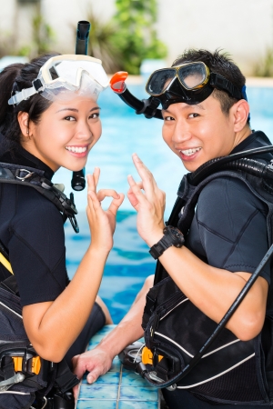 Asian people at the diver Course in diving school in wetsuit with an oxygen tankの写真素材