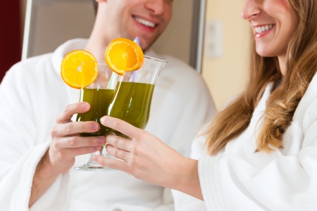 Young couple - man and woman - drinking Chlorophyll-Shake in spaの写真素材