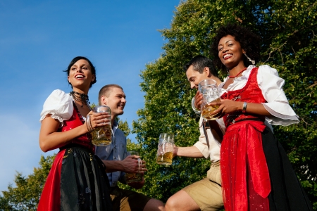 Group of four friends in beer gardenの写真素材