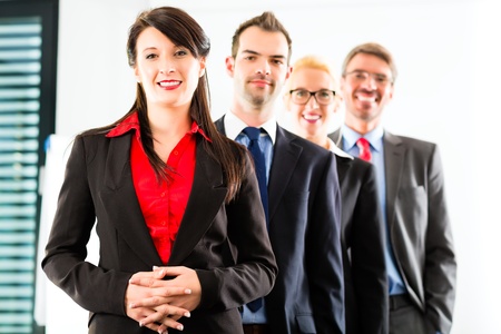 Business - group of successful businesspeople posing for group photo in office Business - group of successful businesspeople posing for group photo in office