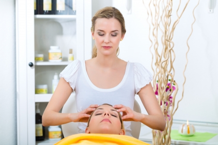 Wellness - woman receiving head or face massage in spaの写真素材